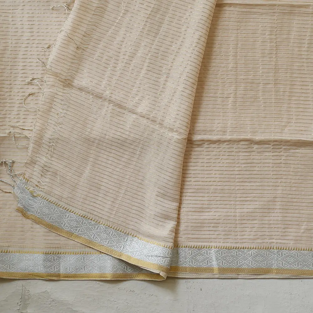 handloom pure cotton saree in luminous moti white featuring delicate micro stripes a woven gold zari border and soft handcrafted tassels