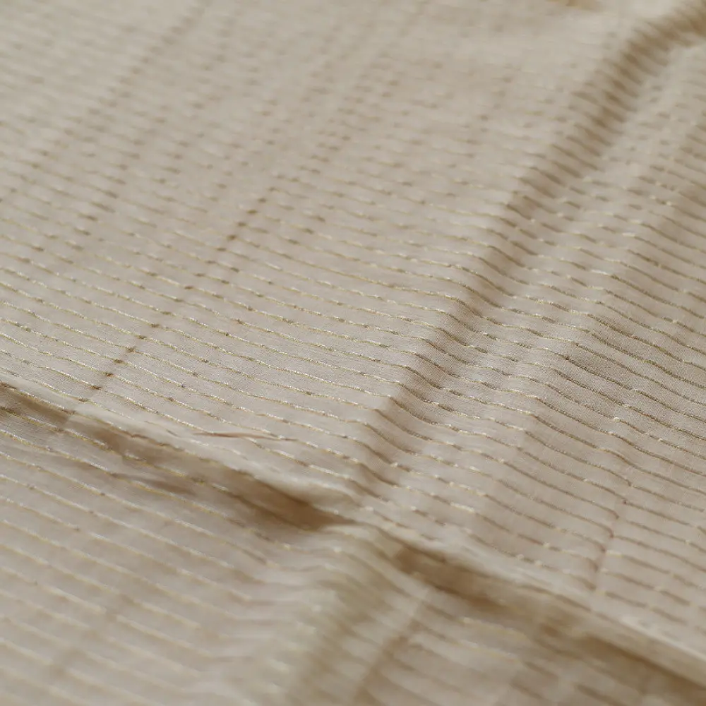 handloom pure cotton saree in luminous moti white featuring delicate micro stripes a woven gold zari border and soft handcrafted tassels