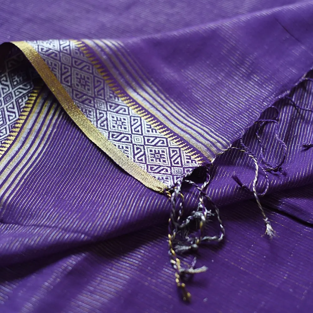 handloom pure cotton saree in deep royal purple featuring a intricate gold woven zari border and handcrafted matching purple tassels