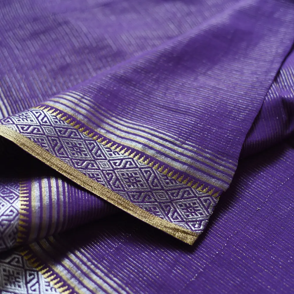 handloom pure cotton saree in deep royal purple featuring a intricate gold woven zari border and handcrafted matching purple tassels