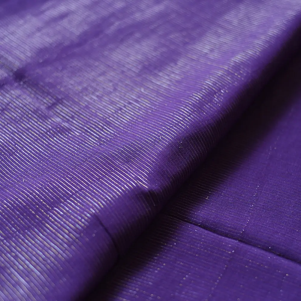 handloom pure cotton saree in deep royal purple featuring a intricate gold woven zari border and handcrafted matching purple tassels