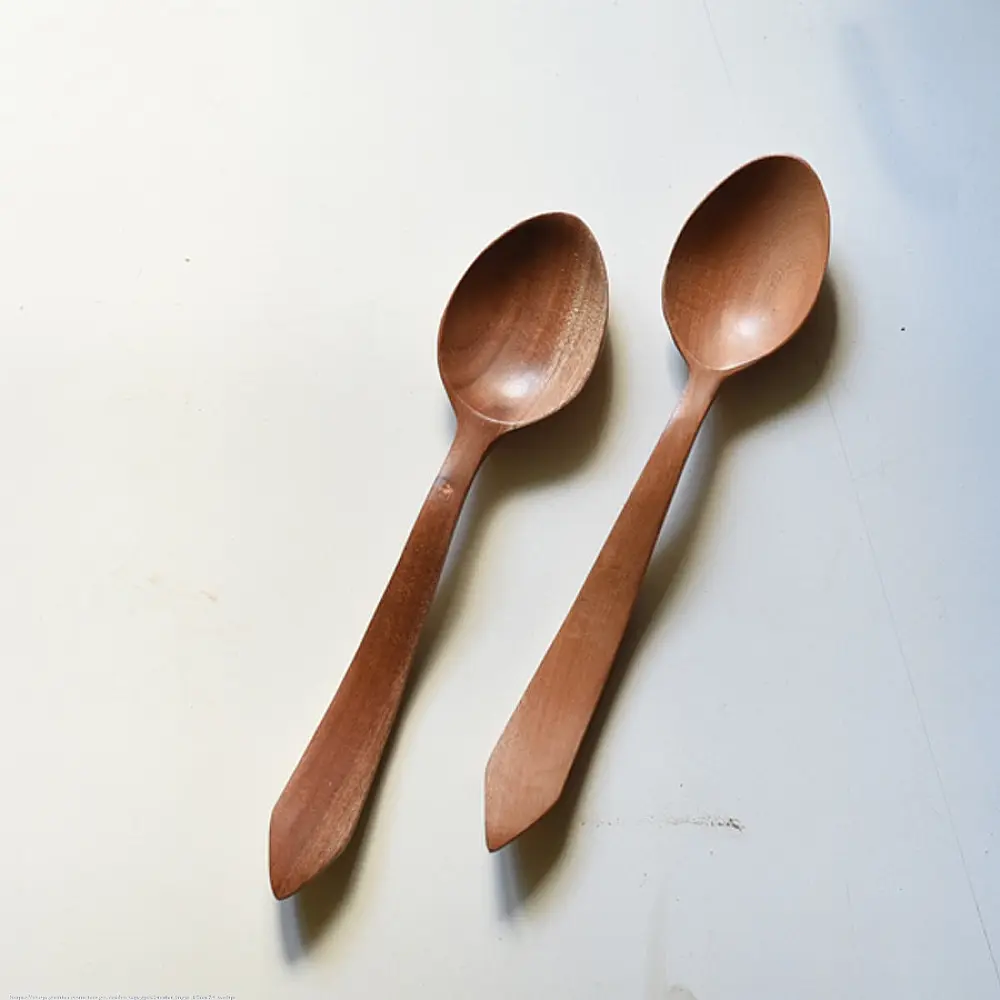 handcarved wooden spoons with smooth rounded bowls and long tapered handles, set of two
