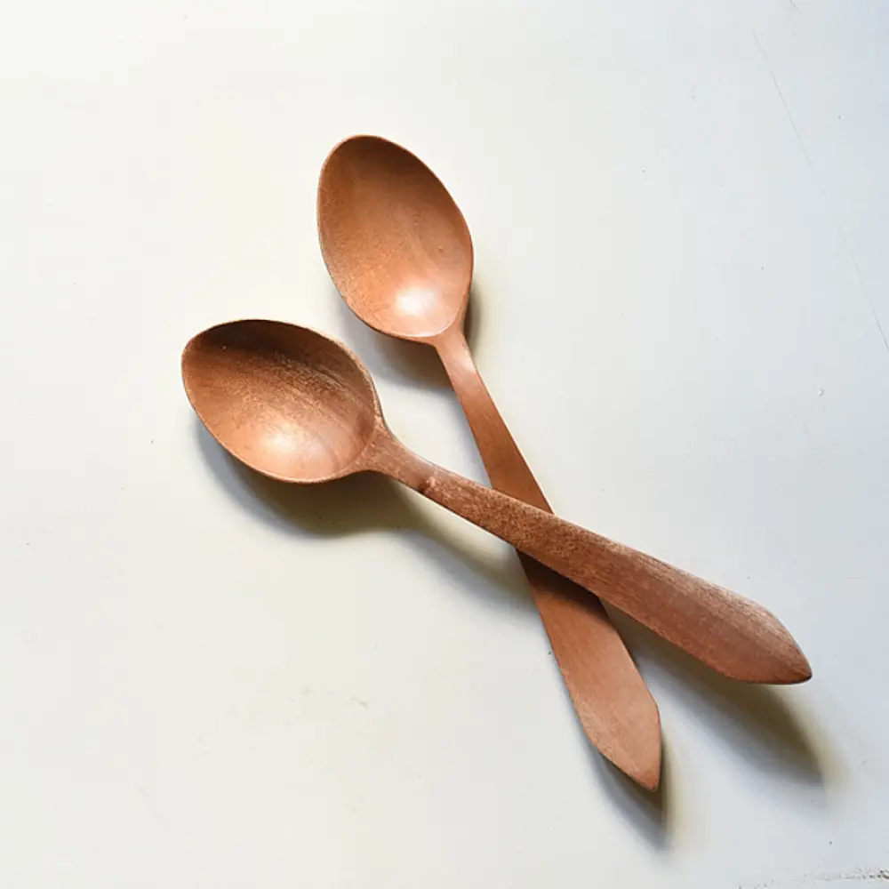 handcarved wooden spoons with smooth rounded bowls and long tapered handles, set of two