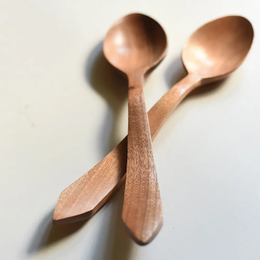 handcarved wooden spoons with smooth rounded bowls and long tapered handles, set of two