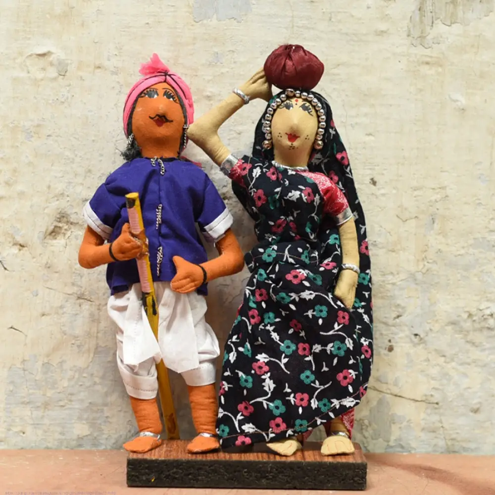 handcrafted tribal bhil fabric dolls featuring a traditional hunter or herder and a woman with a water pot
