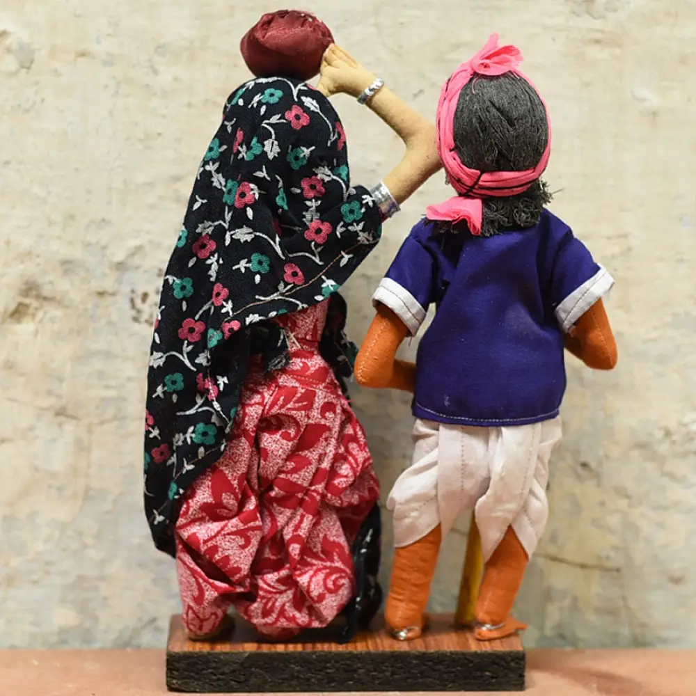 handcrafted tribal bhil fabric dolls featuring a traditional hunter or herder and a woman with a water pot