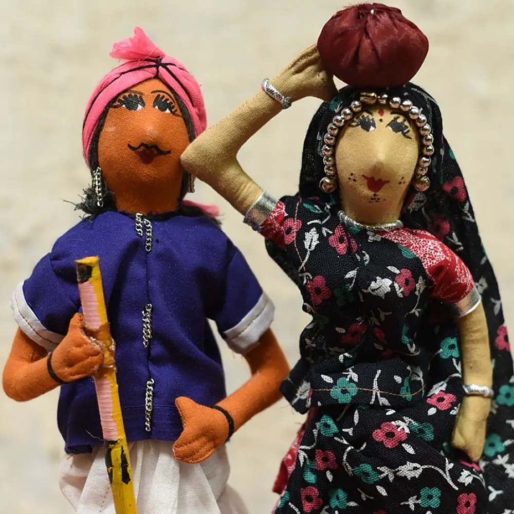handcrafted tribal bhil fabric dolls featuring a traditional hunter or herder and a woman with a water pot