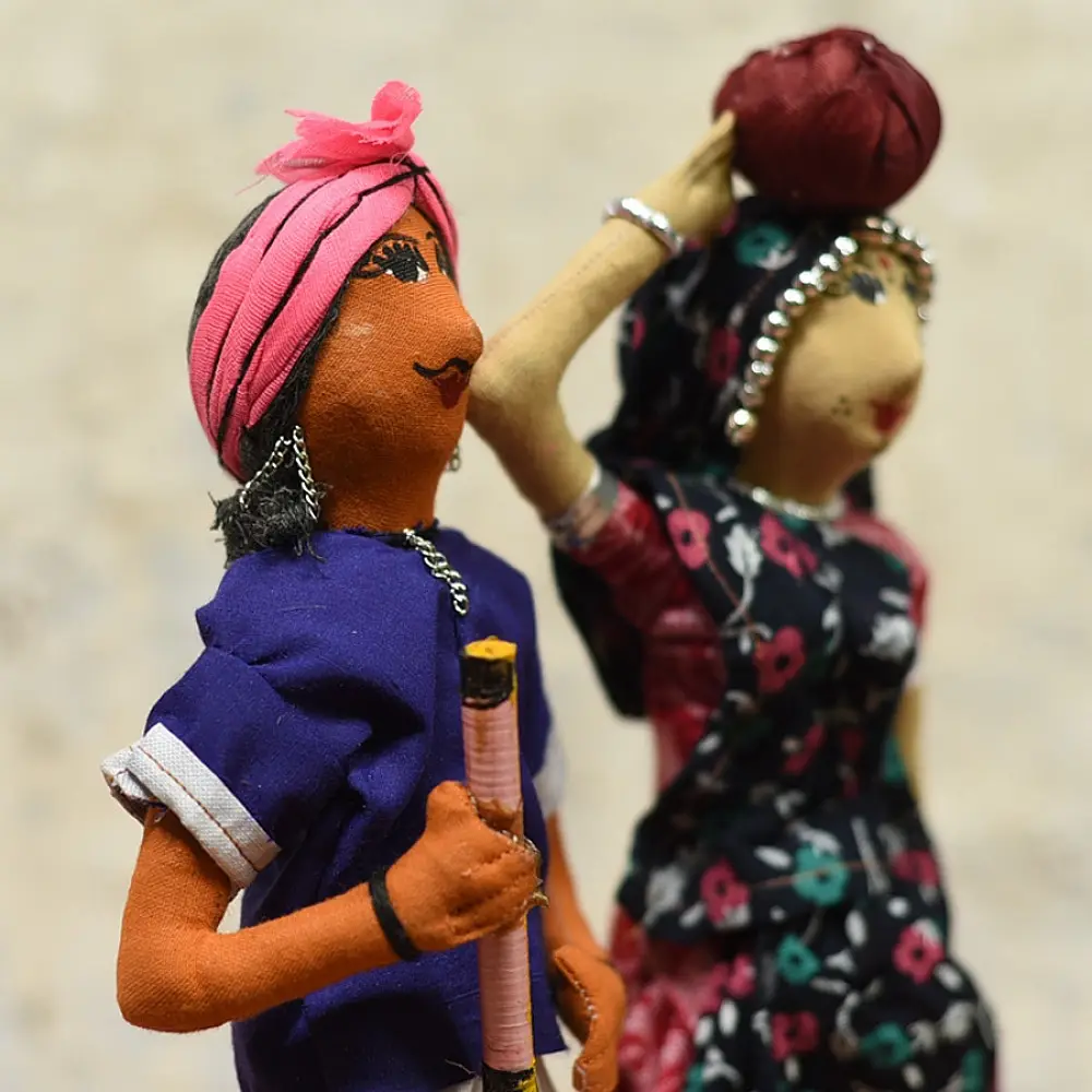 handcrafted tribal bhil fabric dolls featuring a traditional hunter or herder and a woman with a water pot