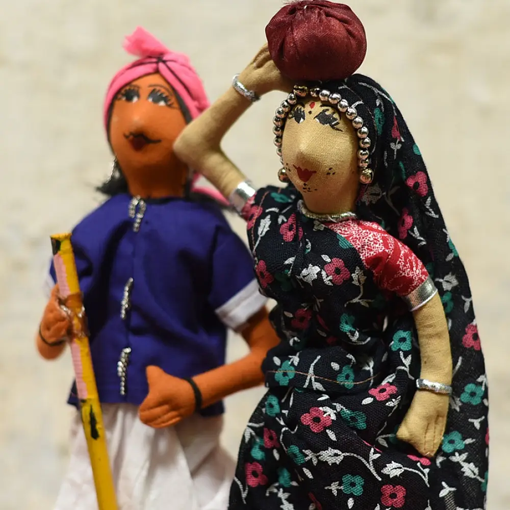 handcrafted tribal bhil fabric dolls featuring a traditional hunter or herder and a woman with a water pot