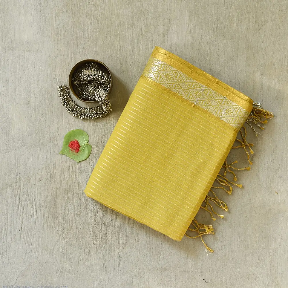 handloom pure cotton saree in subtle olivish mustard yellow featuring delicate micro stripes a woven silver zari border and soft beige handcrafted tassels