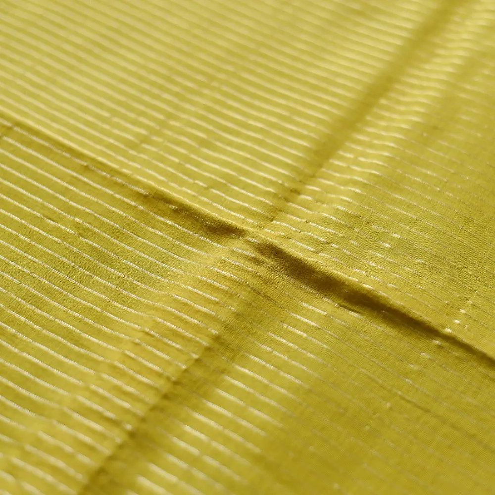 handloom pure cotton saree in subtle olivish mustard yellow featuring delicate micro stripes a woven silver zari border and soft beige handcrafted tassels