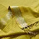 handloom pure cotton saree in subtle olivish mustard yellow featuring delicate micro stripes a woven silver zari border and soft beige handcrafted tassels