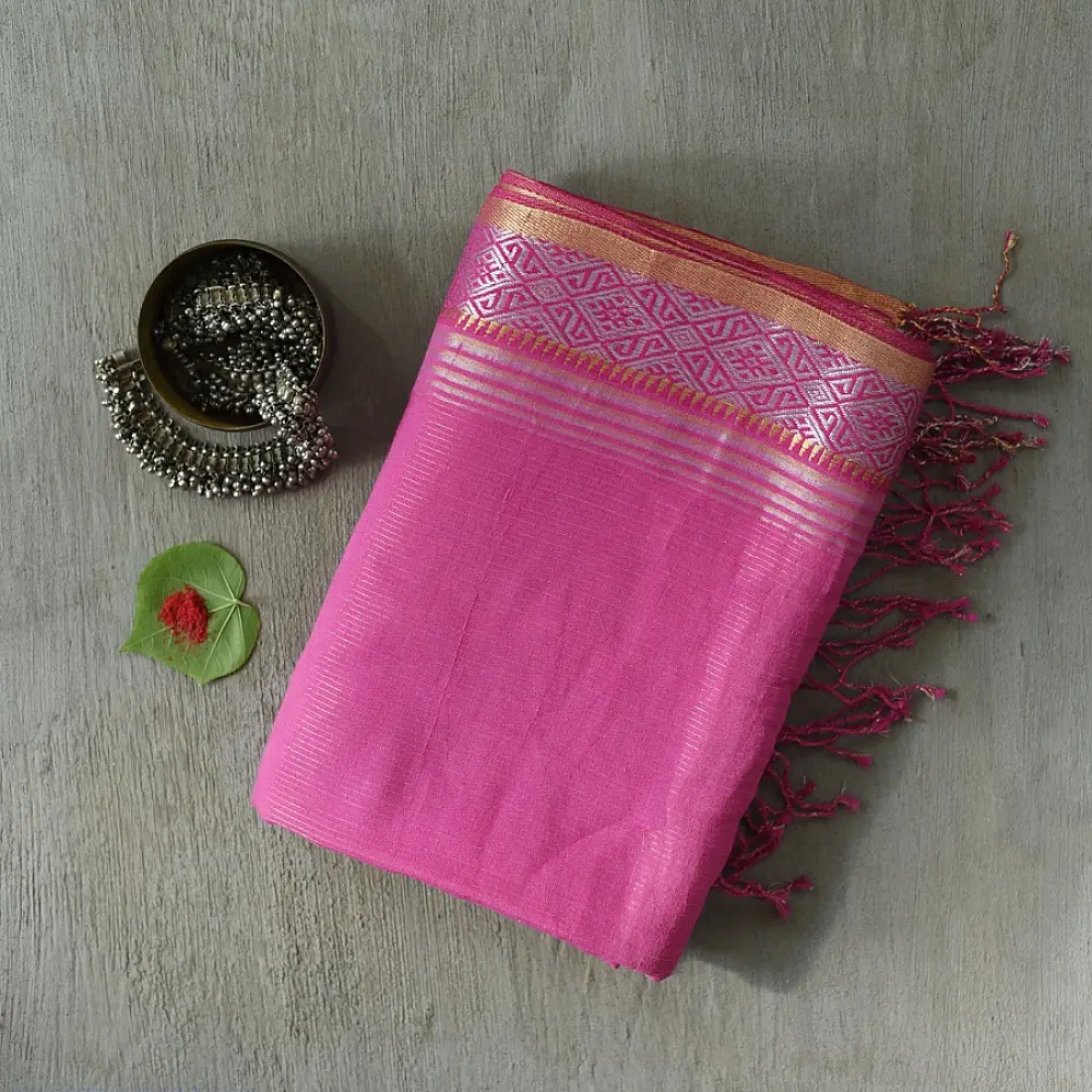 handloom pure cotton saree in soft lotus pink featuring an intricate golden zari woven patterned border and matching handcrafted tassels on pallu   