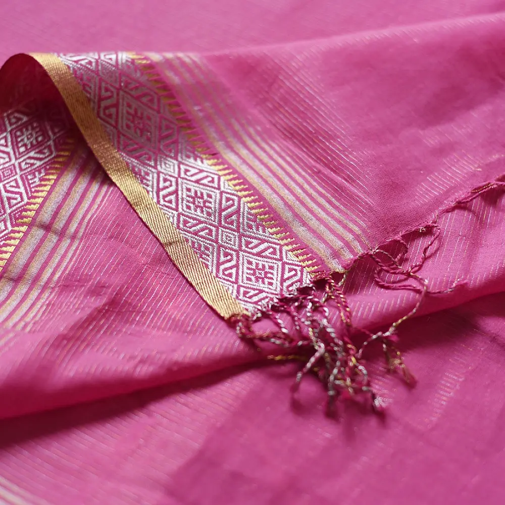 handloom pure cotton saree in soft lotus pink featuring an intricate golden zari woven patterned border and matching handcrafted tassels on pallu   
