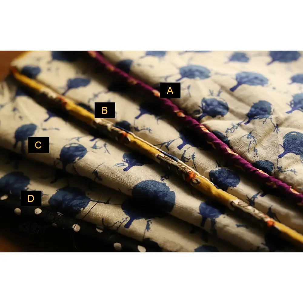 beige cotton iPad cover with indigo blue block-printed tree motif and polka dot border