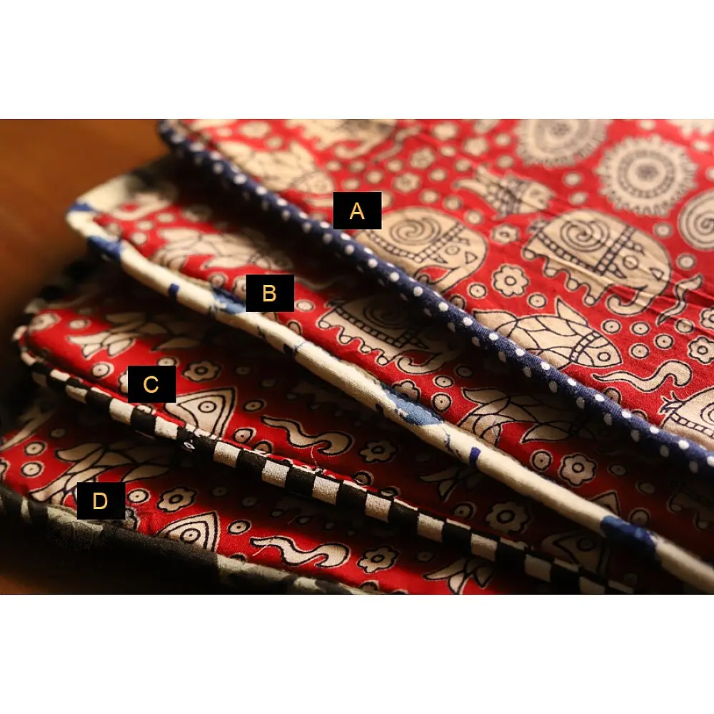 red cotton iPad cover with white block-printed elephant and paisley motifs and polka dot border