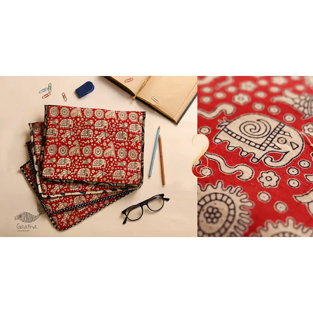 red cotton iPad cover with white block-printed elephant and paisley motifs and polka dot border