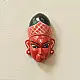 handcrafted hand painted red wooden mask of sugriva with a crosshatched headgear and tilak mark from west bengal