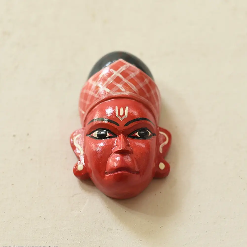 handcrafted hand painted red wooden mask of sugriva with a crosshatched headgear and tilak mark from west bengal