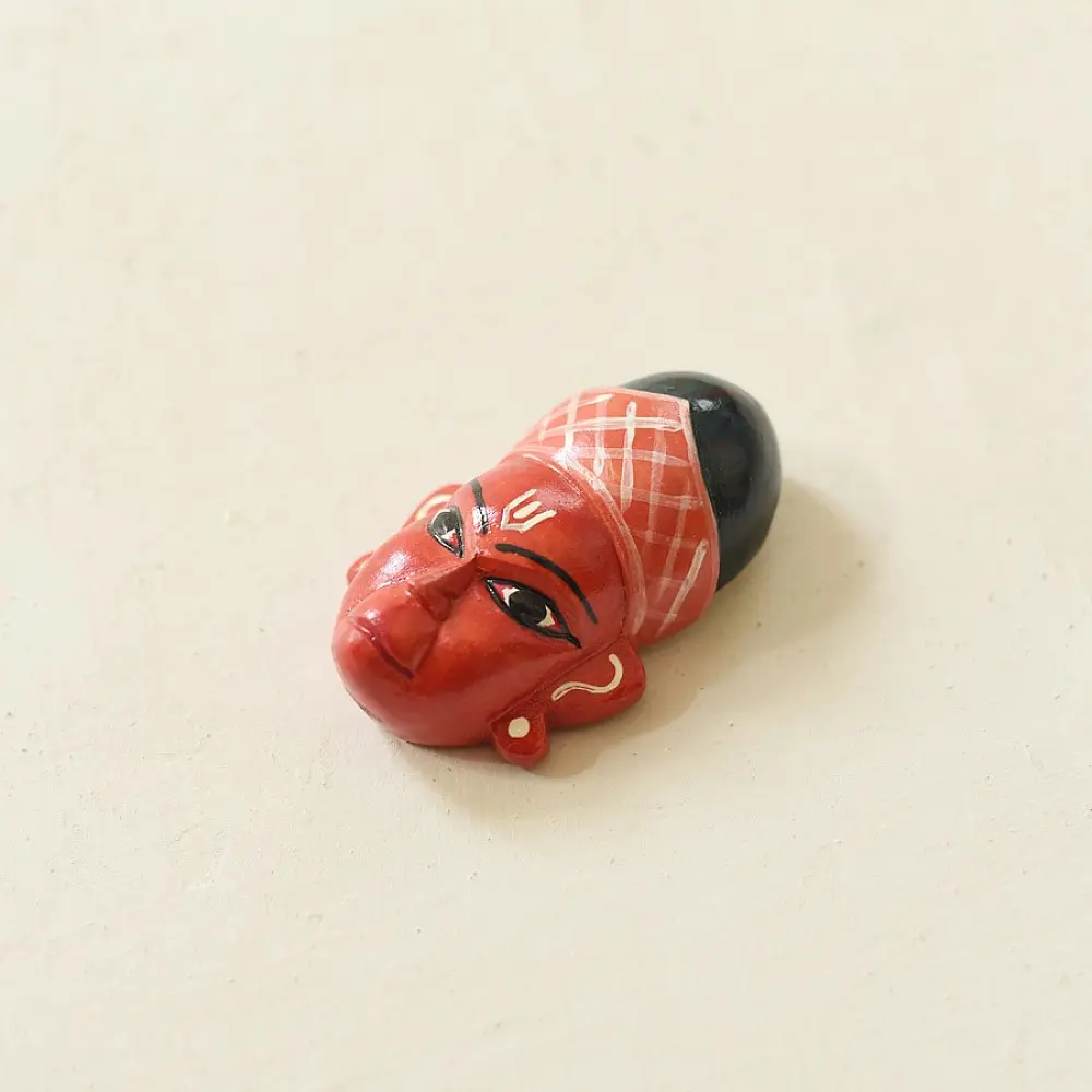 handcrafted hand painted red wooden mask of sugriva with a crosshatched headgear and tilak mark from west bengal