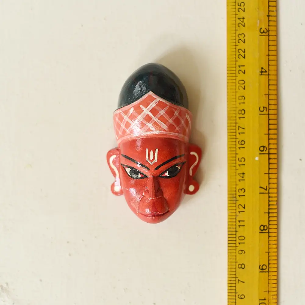 handcrafted hand painted red wooden mask of sugriva with a crosshatched headgear and tilak mark from west bengal