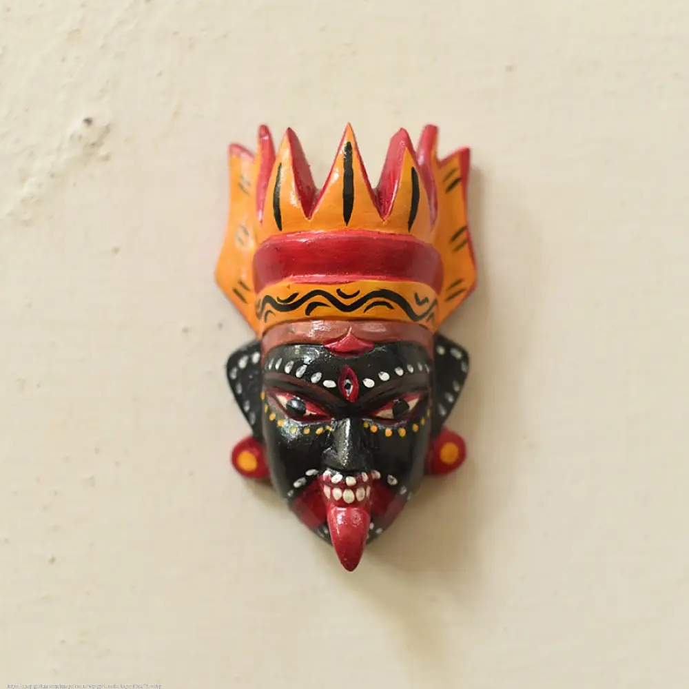 handcrafted hand painted wooden mask of goddess kaali with vibrant crown large expressive eyes and outstretched tongue from west bengal
