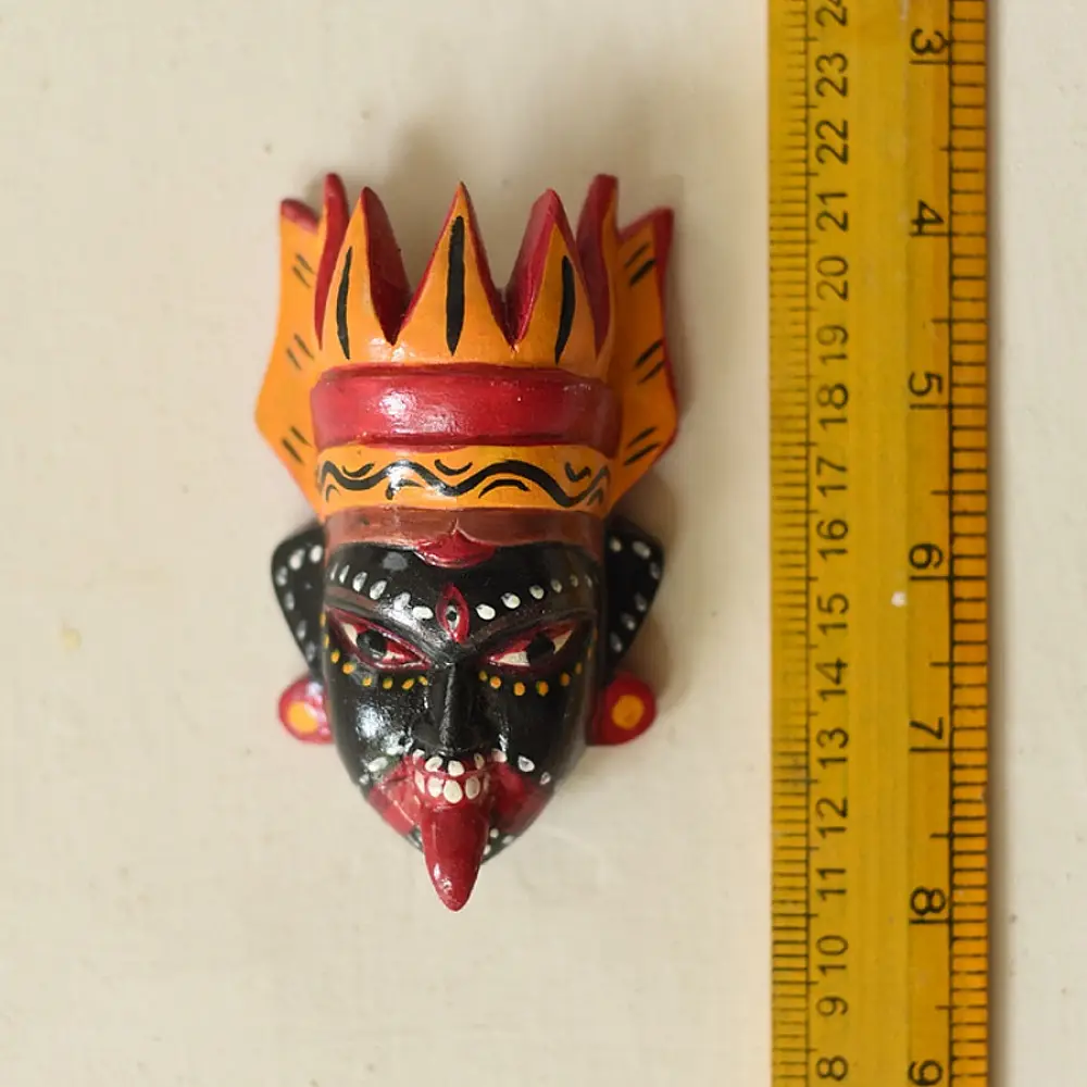 handcrafted hand painted wooden mask of goddess kaali with vibrant crown large expressive eyes and outstretched tongue from west bengal