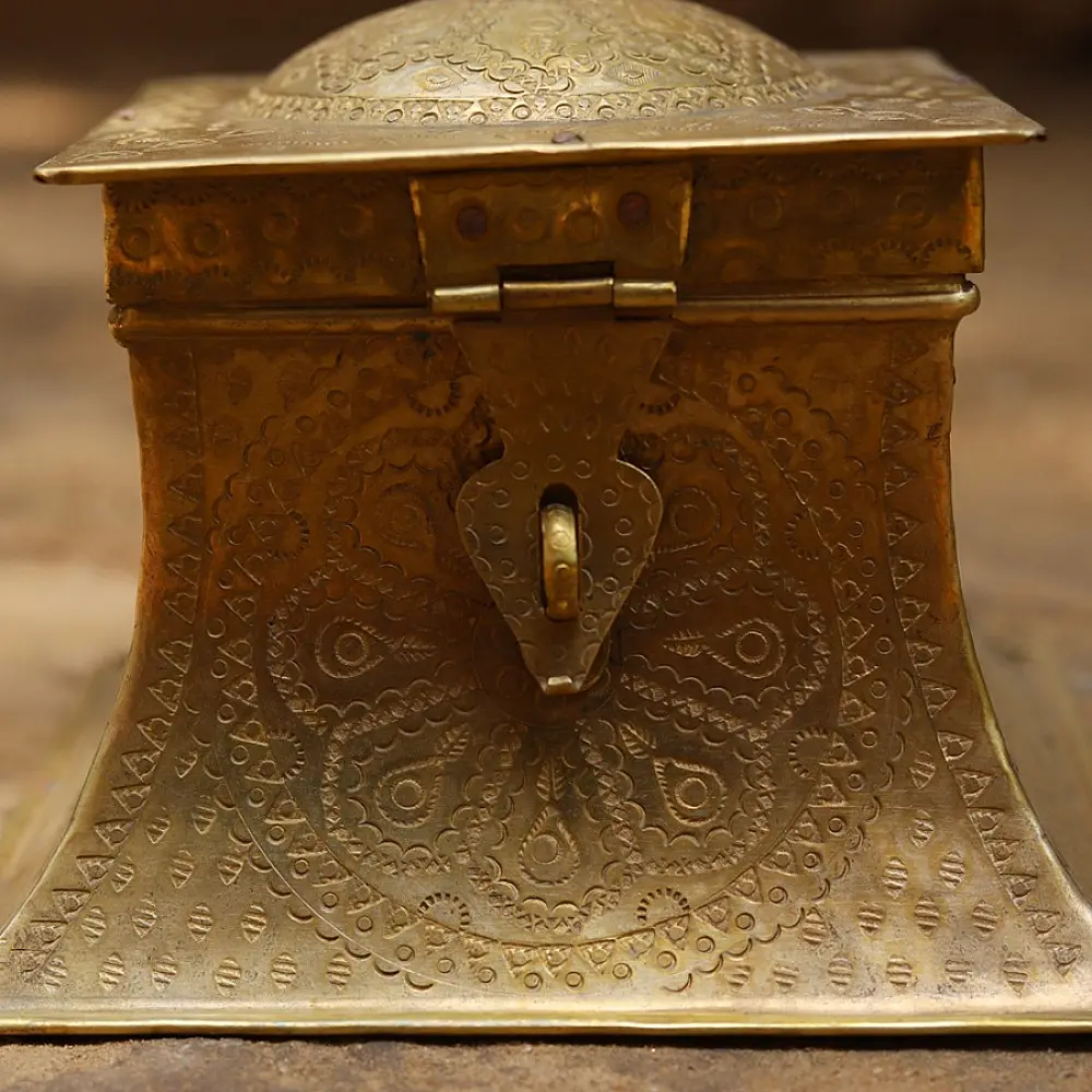 handmade square brass dabro storage box with flared base front clasp and hand engraved patterns