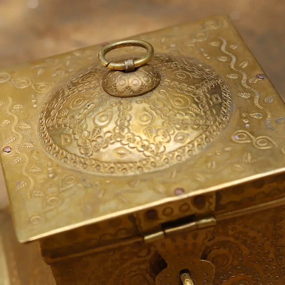 handmade square brass dabro storage box with flared base front clasp and hand engraved patterns