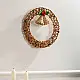 handcrafted circular banana rope woven christmas wreath featuring suspended center bells and red and green crochet holly berry accents