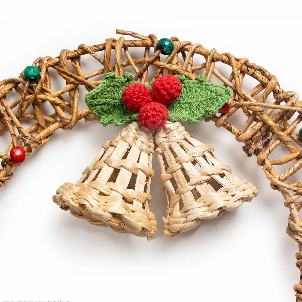 handcrafted circular banana rope woven christmas wreath featuring suspended center bells and red and green crochet holly berry accents