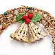 handcrafted circular banana rope woven christmas wreath featuring suspended center bells and red and green crochet holly berry accents