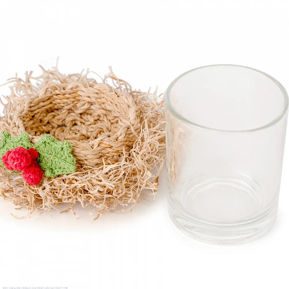 handcrafted natural bamboo fiber frill tea light holder with red and green crochet flower accents holding a clear glass candle cup on a festive display table