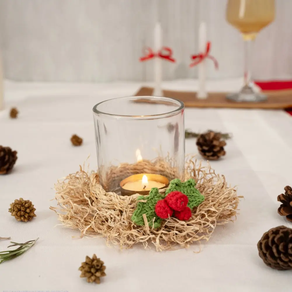 handcrafted natural bamboo fiber frill tea light holder with red and green crochet flower accents holding a clear glass candle cup on a festive display table