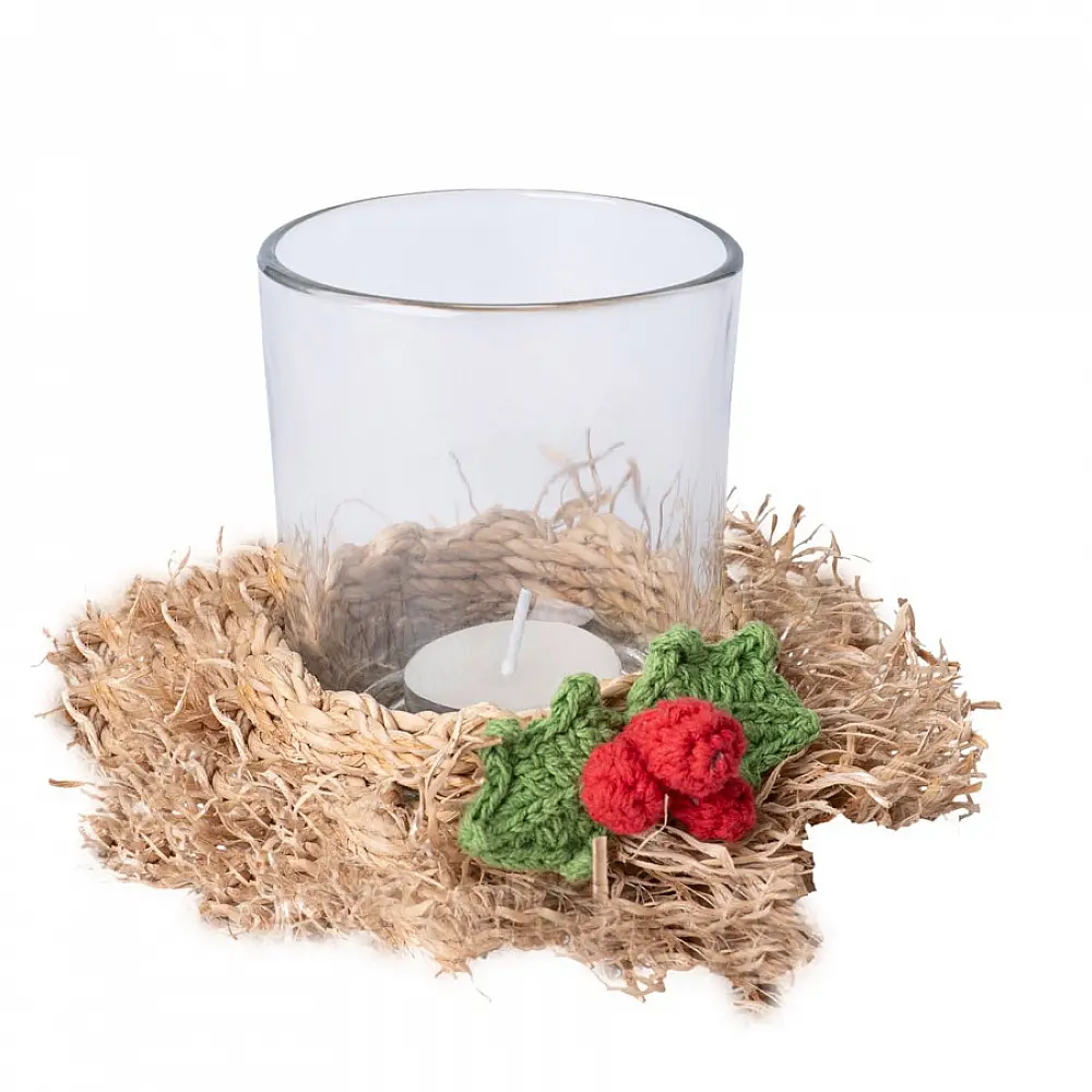 handcrafted natural bamboo fiber frill tea light holder with red and green crochet flower accents holding a clear glass candle cup on a festive display table