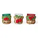 handcrafted banana bark woven tea light holders with green and red crochet holly berry accents holding colored glass candle cups on a festive table display