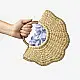 Natural handcrafted water reed handbag with a woven texture, rounded handles and a spacious fabric-lined interior