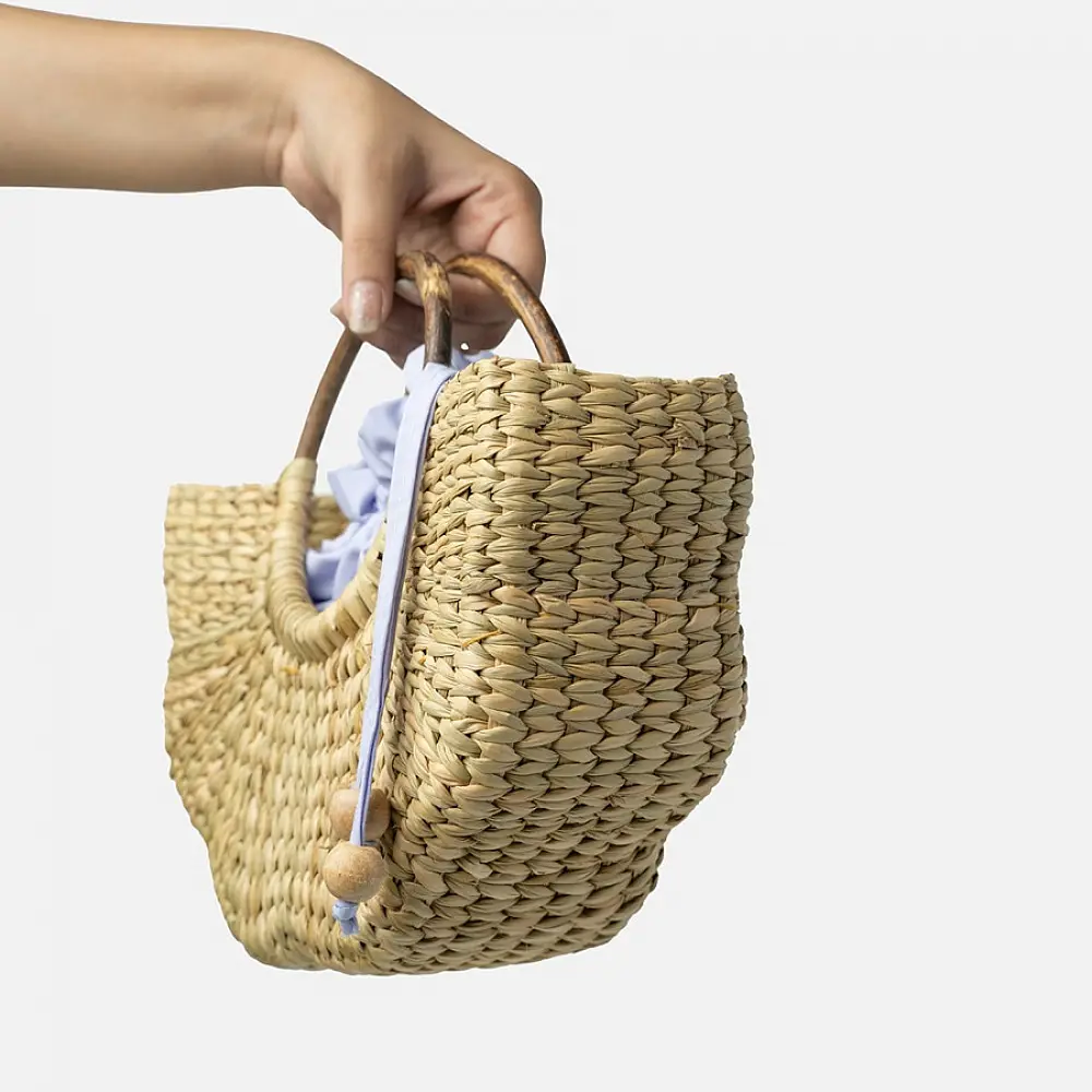 Natural handcrafted water reed handbag with a woven texture, rounded handles and a spacious fabric-lined interior