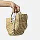 Natural handcrafted water reed handbag with a woven texture, rounded handles and a spacious fabric-lined interior
