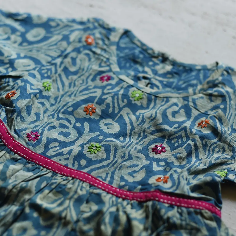blue pure cotton girls frock with floral print pink piping and embroidered details
