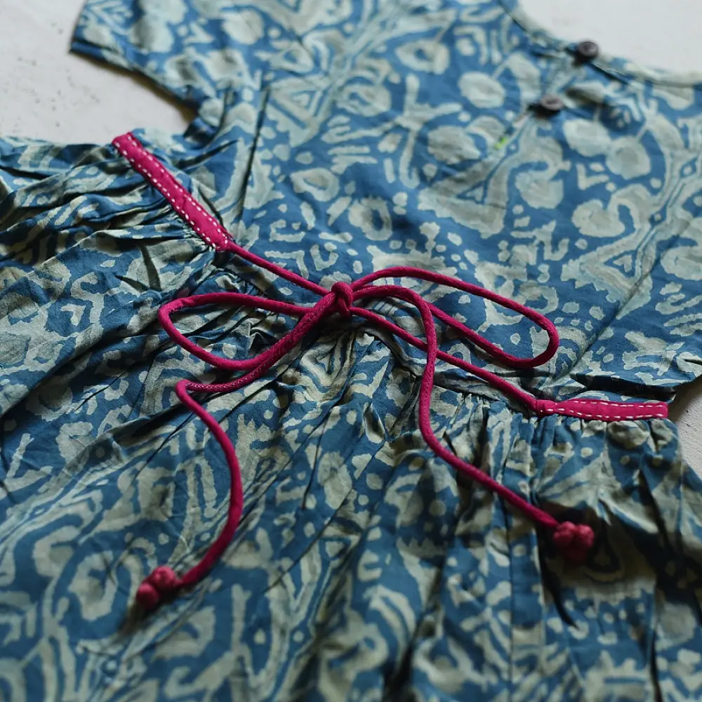 blue pure cotton girls frock with floral print pink piping and embroidered details