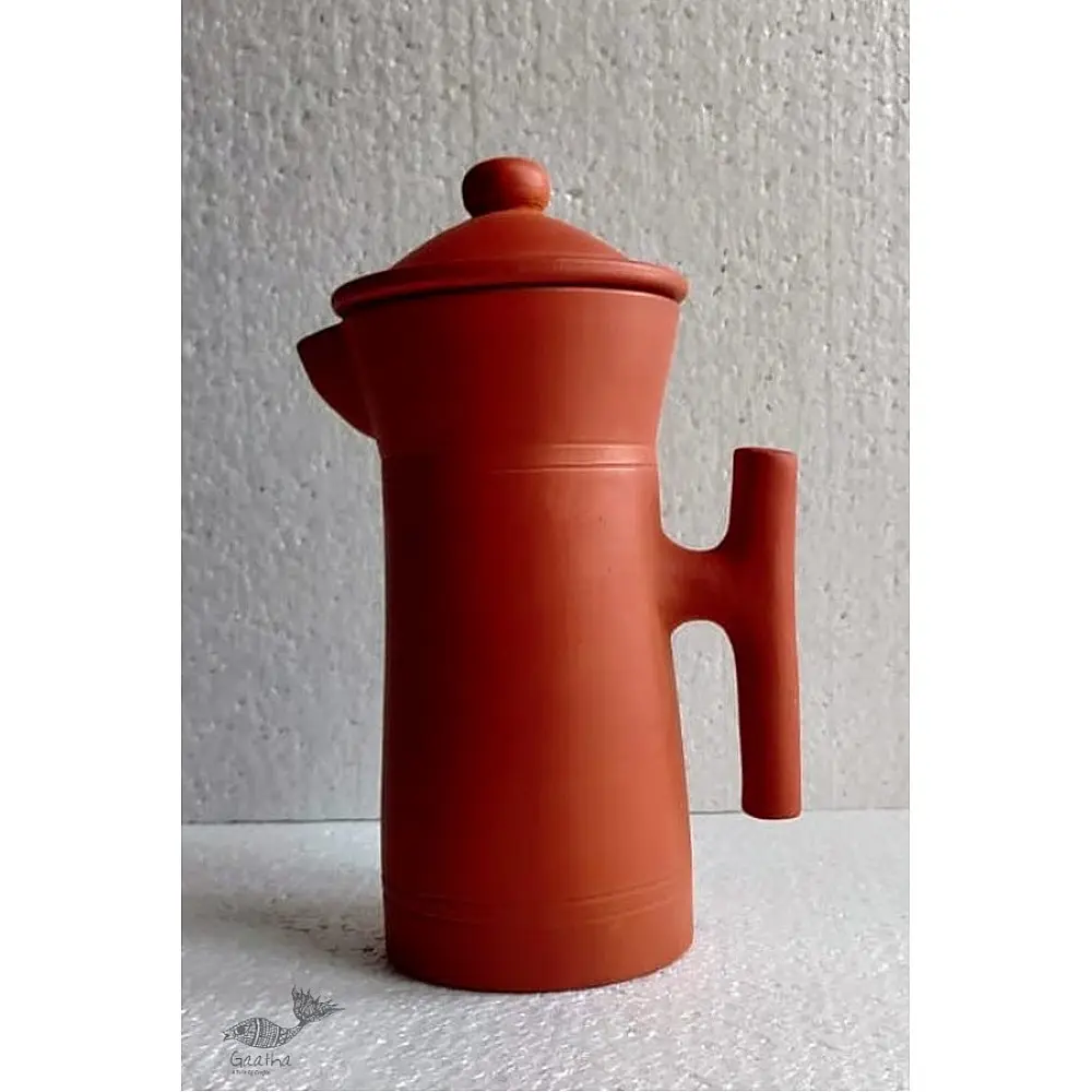 terracotta clay designer jug with fitted lid and curved handle in natural earthy tone