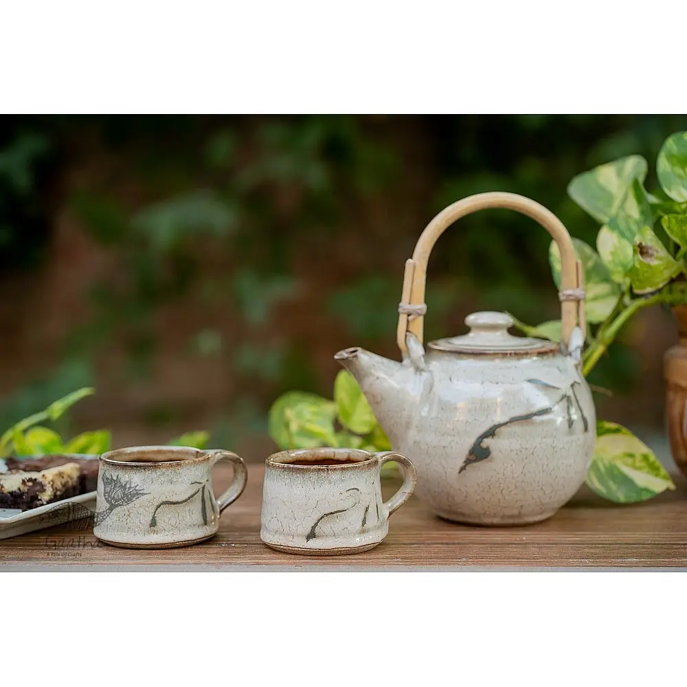 handmade studio ceramic tea cups set of two in light beige brown speckled glaze with hand painted minimal leaf art