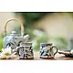 handmade studio ceramic coffee mugs set of two in light blue and white glaze with hand painted botanical leaf motifs
