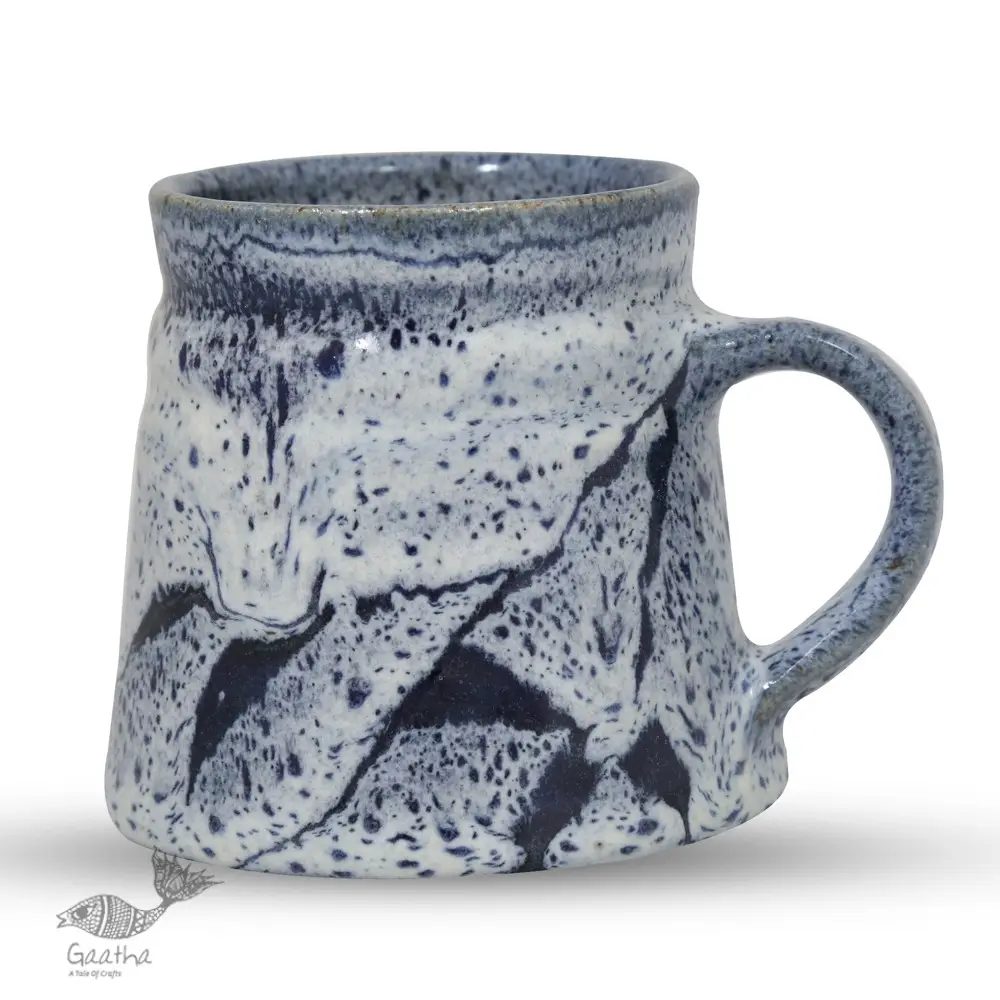 handmade studio ceramic coffee mugs set of two in light blue and white glaze with hand painted botanical leaf motifs
