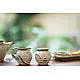 off-white and brown ceramic sugar pot and milk jug set with hand-painted swirl motif