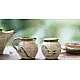 off-white and brown ceramic sugar pot and milk jug set with hand-painted swirl motif
