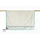 blue fog block printed baby dohar blanket with whimsical monkey and bananas pattern draped over a crib