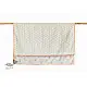 peach apricot block printed baby dohar blanket with whimsical monkey and bananas pattern draped over a crib