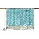 blue and teal block printed baby quilt with whimsical unicorns and rainbows pattern draped over a crib